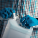 75811439 - unrecognizable male farmer with unlabeled plastic tank canister containing pesticides for plant processing in agriculture