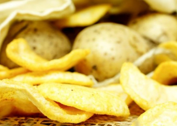 Natural potato chips in a package and potatoes in the bag