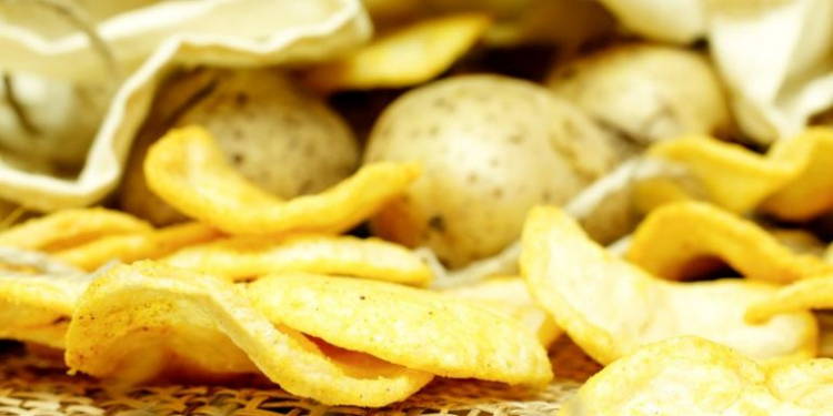 Natural potato chips in a package and potatoes in the bag