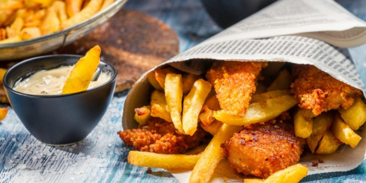 Closeup of Fish & Chips served in the newspaper