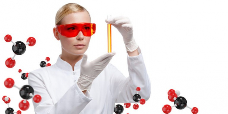 Young woman doctor in glasses hands vial on chemical combination background. Research concept.