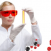 Young woman doctor in glasses hands vial on chemical combination background. Research concept.