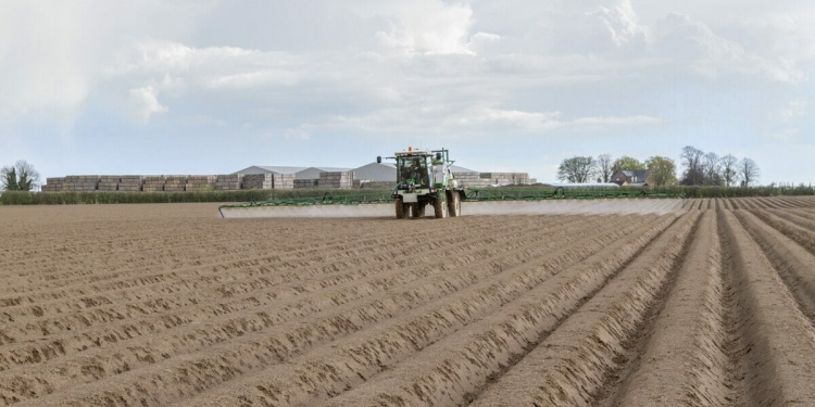 Spraying pre emergence residual herbicide onto potatoes - Lincolnshire, April