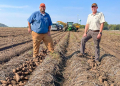 Beau Hartline and Joe Hartung in potato field