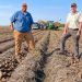 Beau Hartline and Joe Hartung in potato field