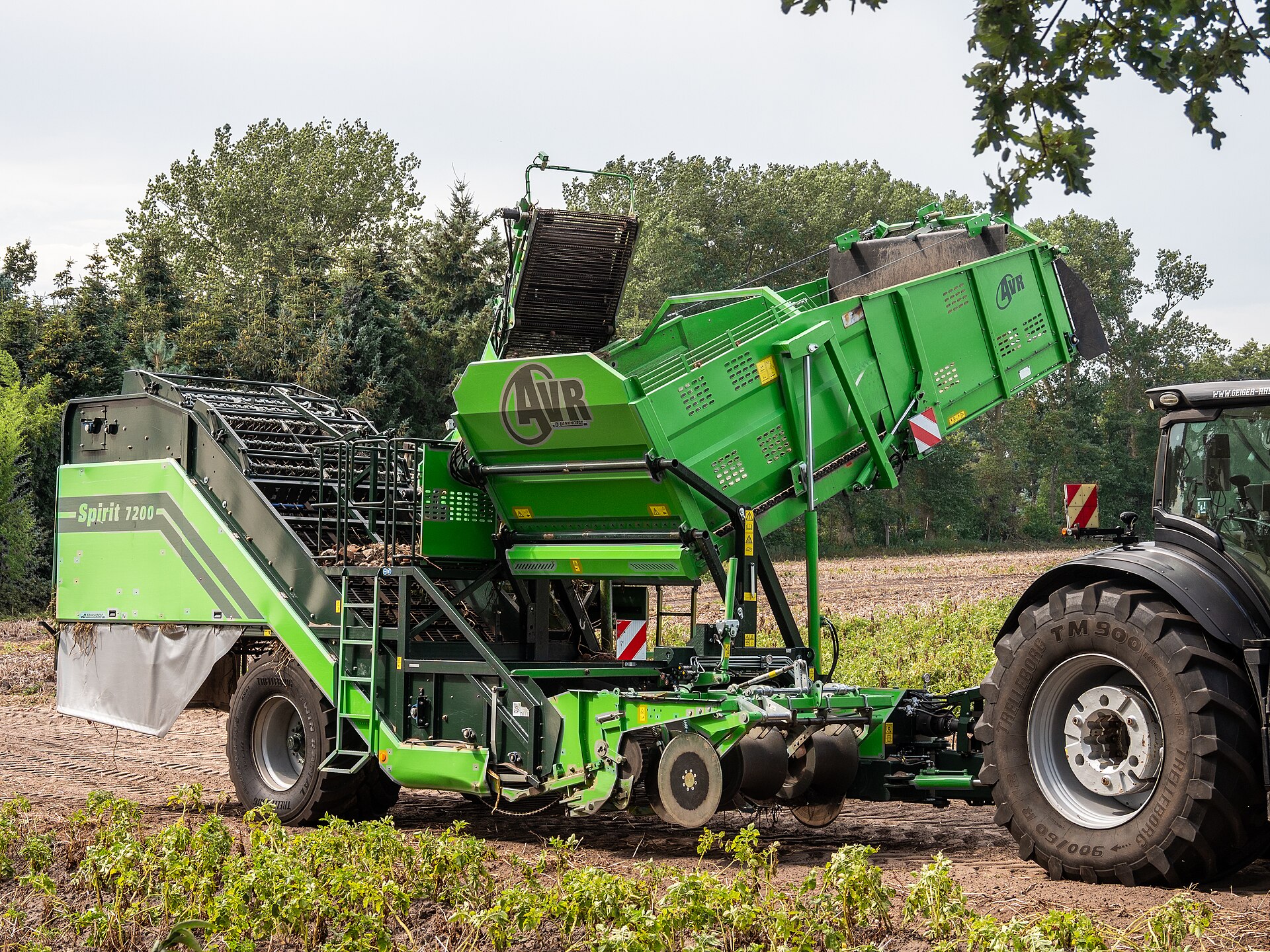 Two-row potato harvester working in a German field