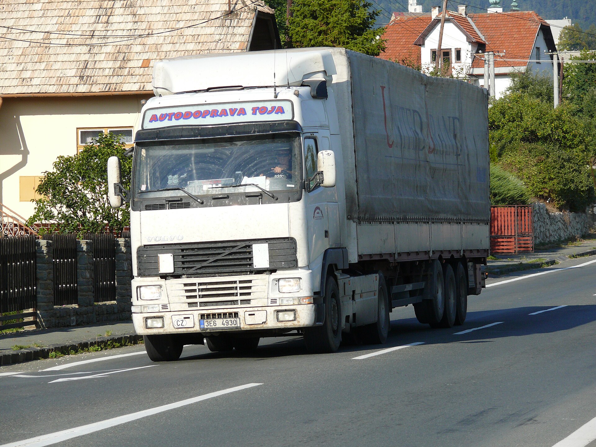 A cargo truck with a semi-trailer on a highway, illustrating road freight logistics