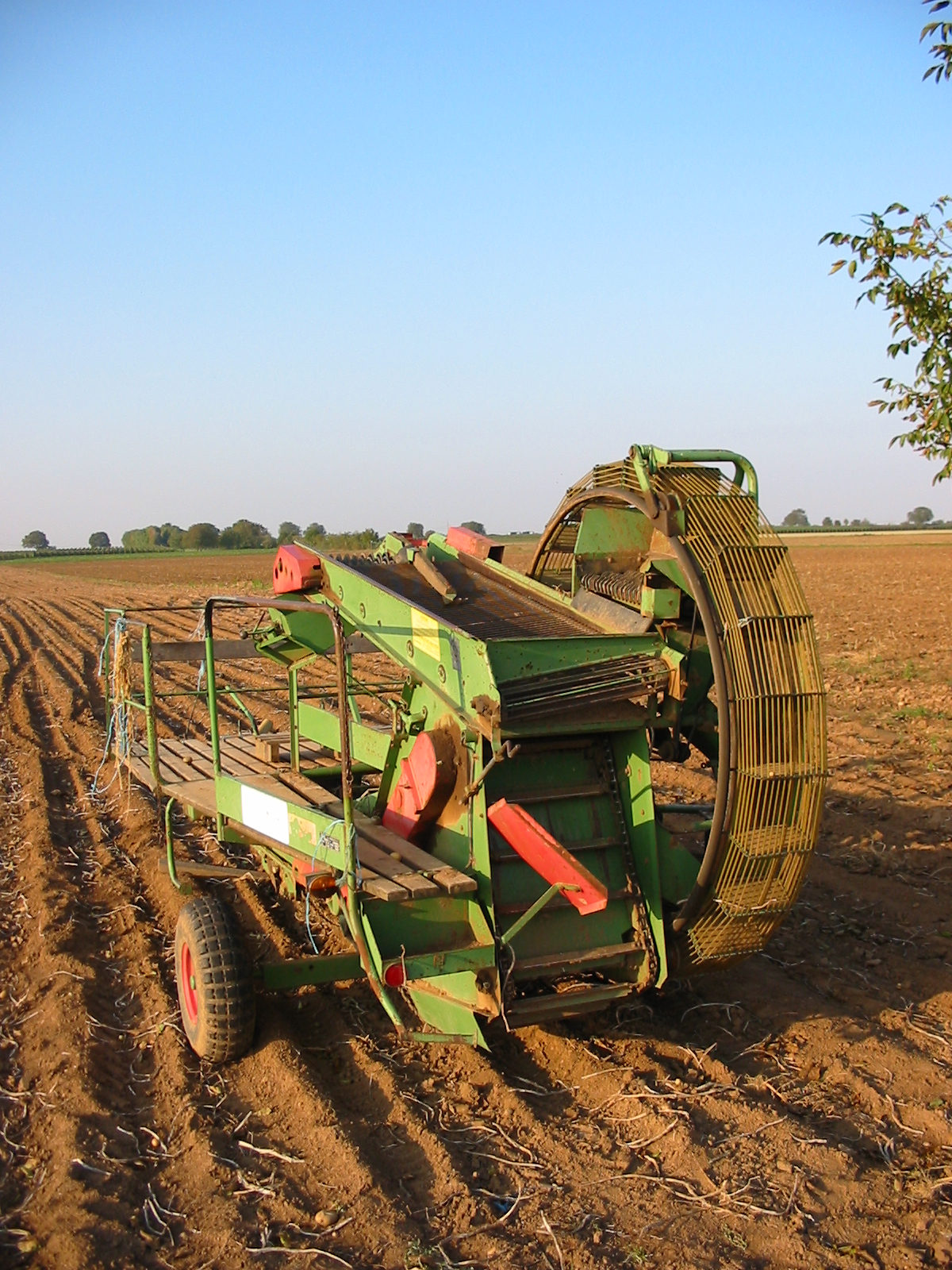 A potato harvester working a harvested potato field in Haßloch, Germany