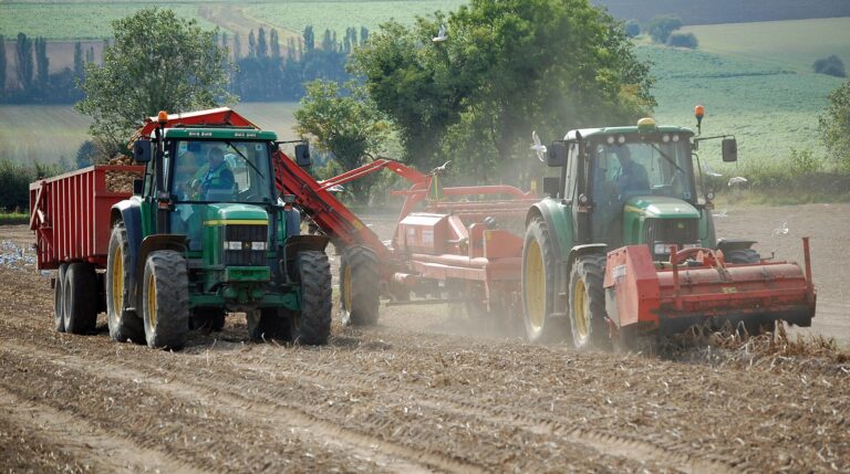 Potato lifting with a tractor and a trailed harvester near Bonby, North Lincolnshire, England, in 2011