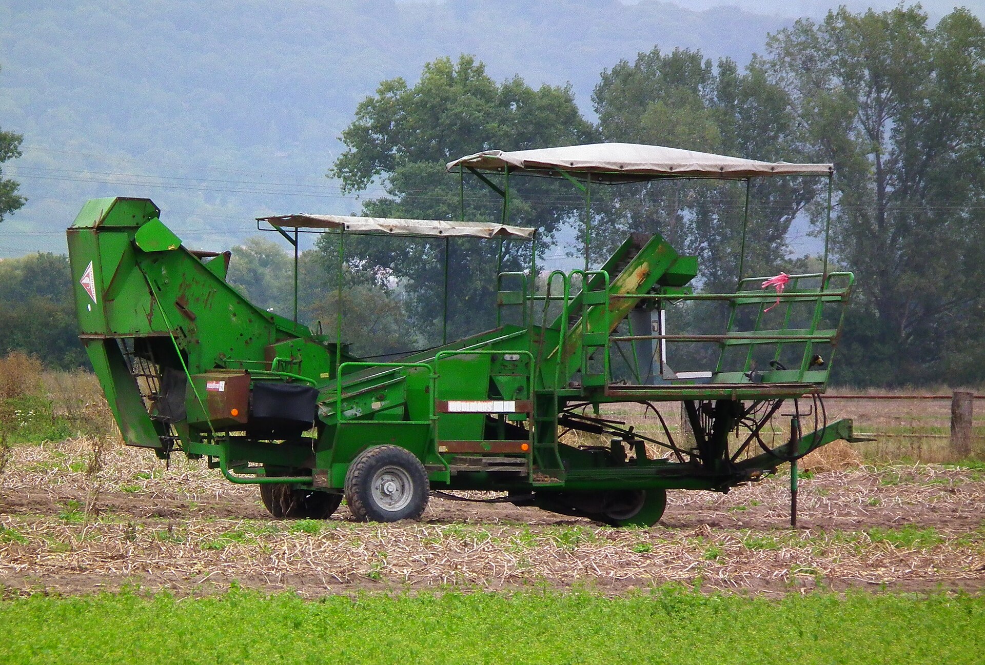 A modern potato harvesting combine working in a field
